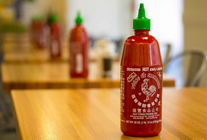 Sriracha on restaurant tables. Photo by Steven Depolo