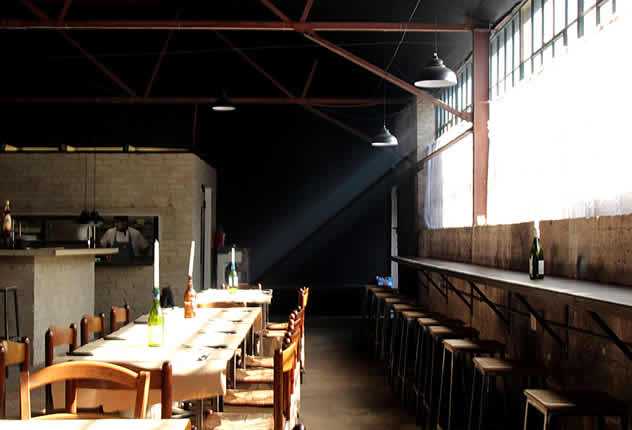 Light shining through a wiindow at Che Argentine Grill. Photos courtesy of Rupesh Kassen.