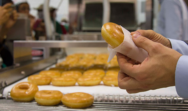 Hot glazed doughnuts, fresh from the production line. Photo by Rupesh Kassen.