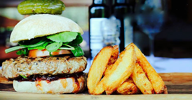 A burger and potato wedges at Floreal Brasserie. Photo courtesy of the restaurant.