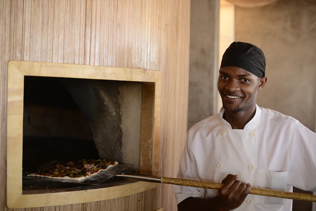 The chef removing a pizza from the oven at Surf Riders Food Shack. Photo courtesy of the restaurant.