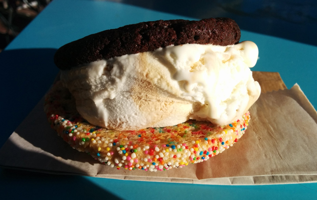 A sandwich made with a brownie cookie and a rainbow cookie. Photo by Katharine Jacobs