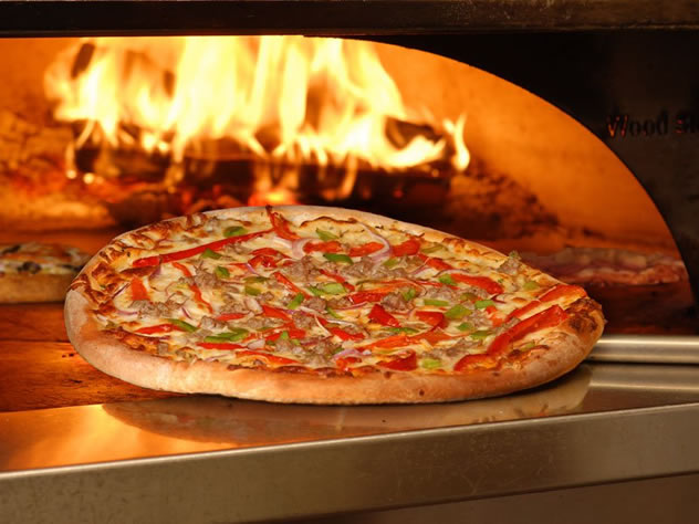 A pizza coming out of the oven at Vini's. Photo courtesy of the restaurant.