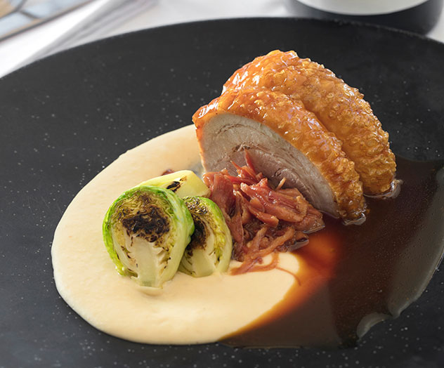 The smoked ham hock with glazed pork belly, cannellini beans, Brussels sprouts and cider jus. Photo supplied.