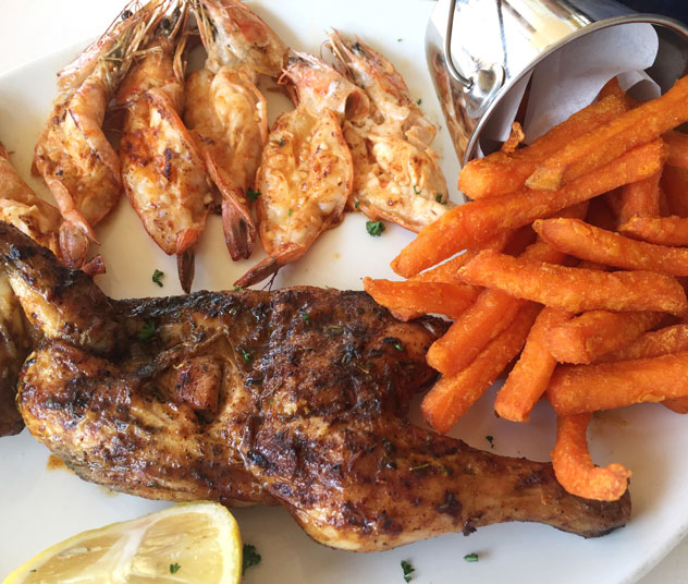 Chicken and prawn combo served with sweet potato fries at Carlita's. Photo supplied.