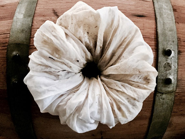 Filtering a barrel of vermouth with muslin. Photo supplied.