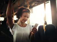 woman on bus listening to music