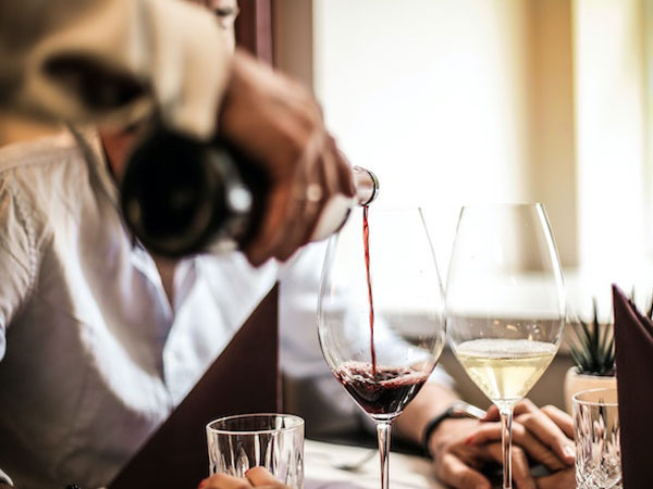 What do restaurants consider when crafting a wine list?