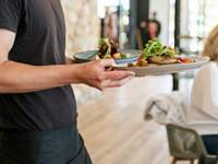 WAITER SERVING FOOD IN RESTAURANT