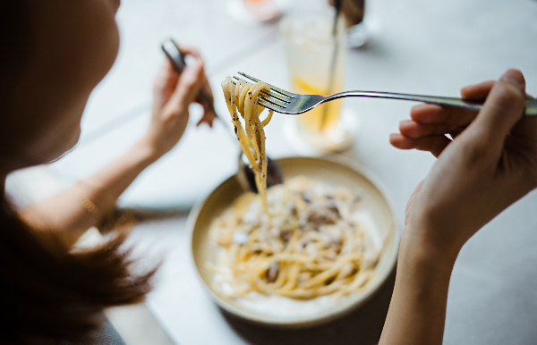 woman eating pasta